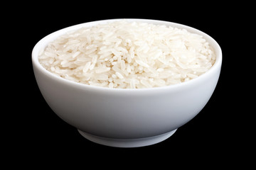Bowl of uncooked white long grain rice on black. Clipping path.