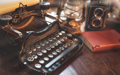 vintage photography still life with typewriter, folding camera,