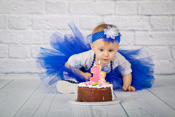Baby girl and her birthday cake