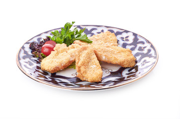 pile of chicken nuggets on white plate with sauce
