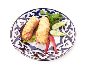 pile of chicken nuggets on white plate with sauce