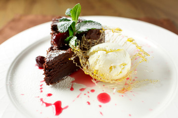 Chocolate brownie with cherries and vanilla ice cream
