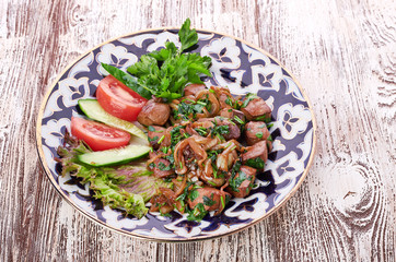 Fried meat with onion in a frying pan