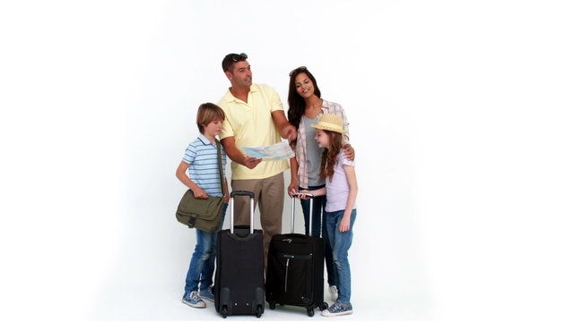 Happy family with luggage pointing