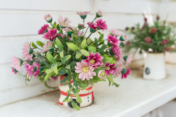 Artificial flowers in the basket in vintage theme