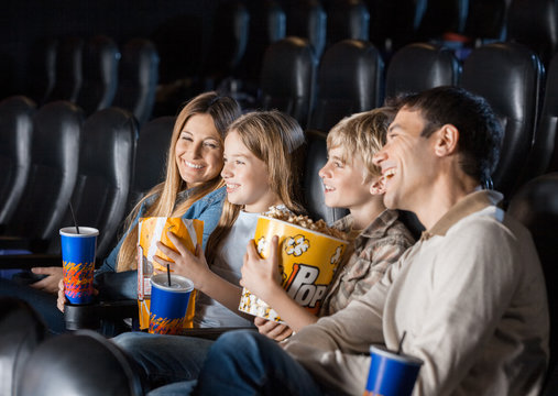 Family Enjoying Movie In Theater