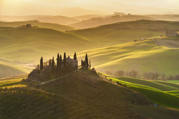 Spring wonderful landscape of Tuscany, green fields, sunrise and