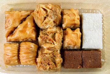 Variety of Turkish baklava in a plastic box