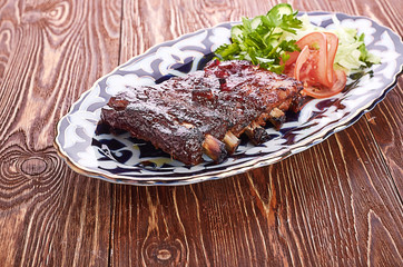 Meat on a grill with vegetables