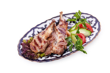 Meat on a grill with vegetables