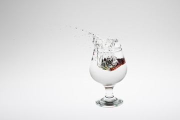Red strawberry inside flowing water