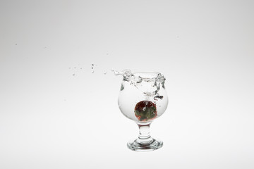 Red strawberry inside flowing water
