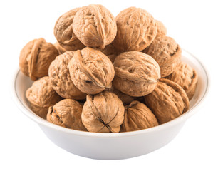 Walnuts in a white bowl over white background