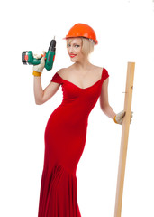 Beautiful blonde in a red dress with an electric drill