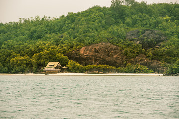 View of Seychelles coastline with a house in the forest