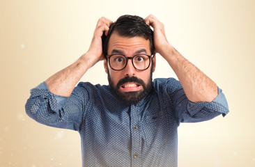 frustrated young hipster man over white background