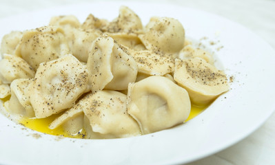 cooked pelmeni sprinkle with pepper