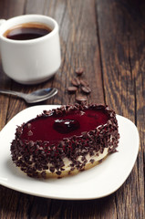 Cake with cherry jelly and coffee