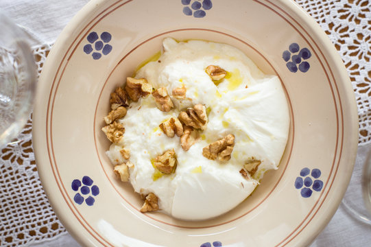 Italian Burrata Cheese Served With Olive Oil and Walnuts