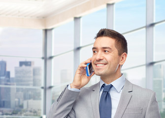 happy businessman calling on smartphone