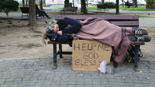 Tired homeless woman