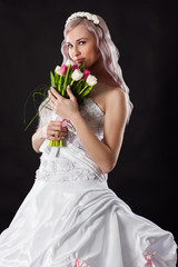 happy bride in a wedding dress with a bouquet of tulips