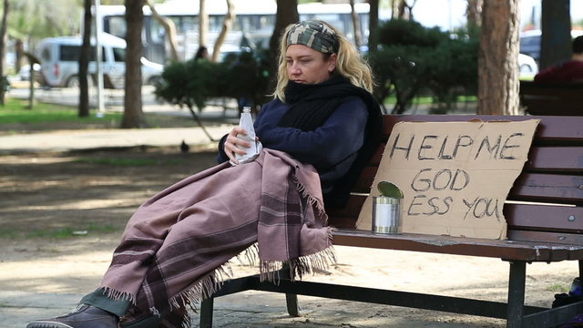 Homeless alcoholic woman drinking wine