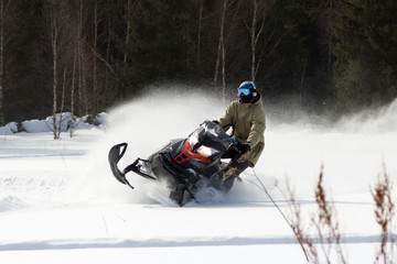 Fototapeta na wymiar Athletes on a snowmobile.