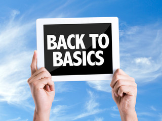 Tablet pc with text Back to Basics with sky background