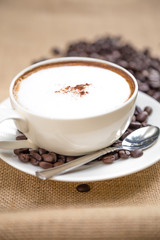 Cappuccino coffee cup and beans