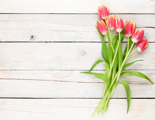 Colorful tulips on wooden table