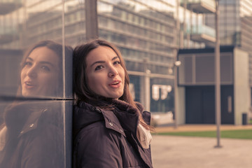 Young beautiful girl posing in the city streets