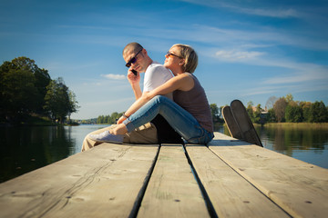 couple relaxing on a pier