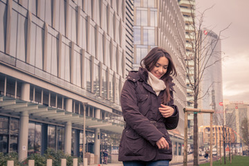 Fototapeta premium Young beautiful girl posing in the city streets