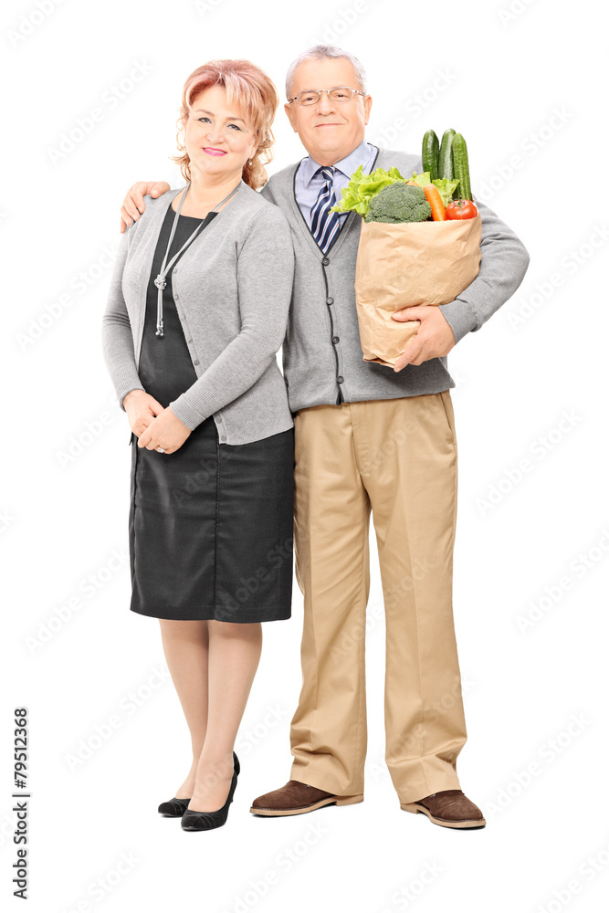 Wall mural mature couple posing with a bag of groceries