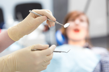 Dental mirror and probe on  background of patient