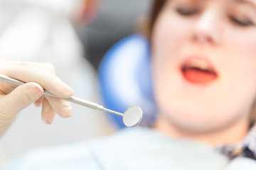 dental mirror on background of  patient