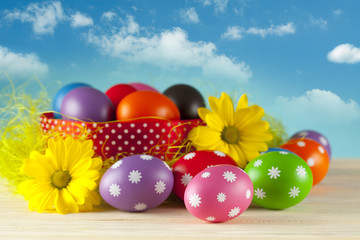Colored Easter eggs on blue sky background