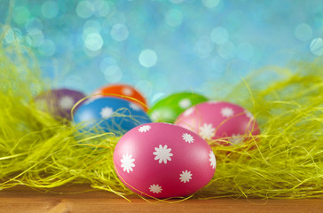 Fototapeta na wymiar Colored Easter eggs on blue background