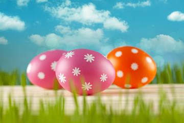 Colored Easter eggs on blue sky background