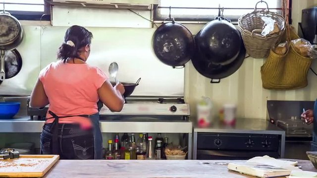 two women cooking in outdoor kitchen in mauritius