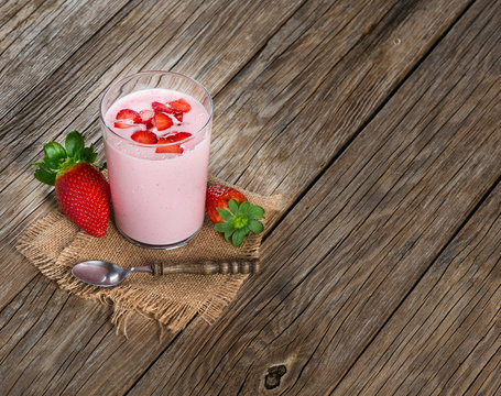 Fresh yogurt in a glass with strawberries