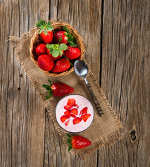 Glass of strawberry yogurt, with fresh strawberries