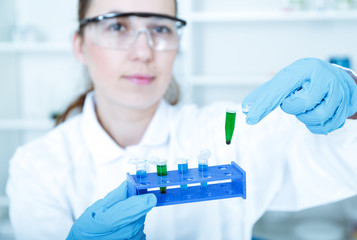 female researcher with  equipment in the lab 