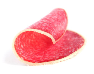 Slice of salami isolated on white background