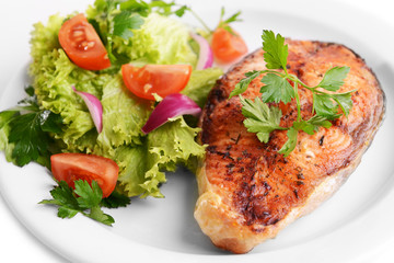 Tasty baked fish on plate close-up