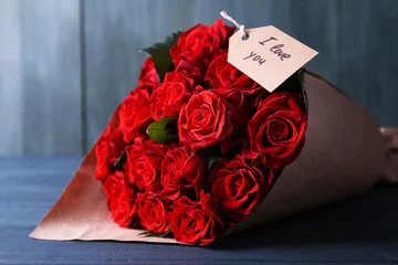 Wallpaper murals Roses Bouquet of red roses with tag wrapped in paper