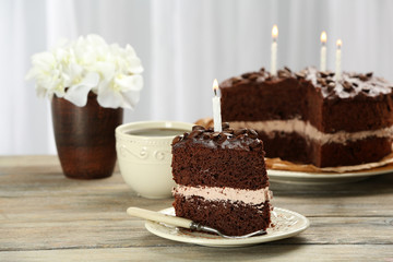 Delicious chocolate cake on table on light background