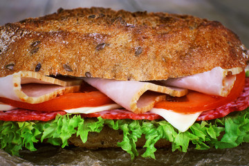 Fresh and tasty sandwich with ham and vegetables close up