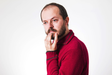 Fototapeta na wymiar Man in red sweater, with beard and mustaches in skeptic pose